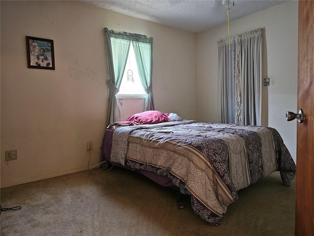 bedroom featuring a textured ceiling and carpet floors