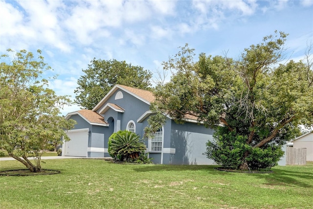 obstructed view of property with a front lawn and a garage