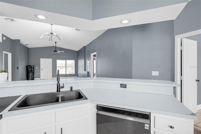 kitchen featuring vaulted ceiling, white cabinets, ceiling fan, stainless steel dishwasher, and sink