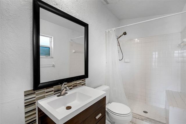 bathroom with walk in shower, backsplash, vanity, and toilet