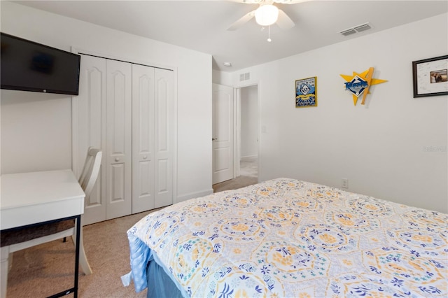 carpeted bedroom featuring a closet and ceiling fan