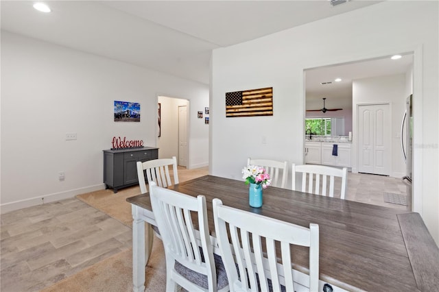 dining space featuring ceiling fan and light hardwood / wood-style flooring