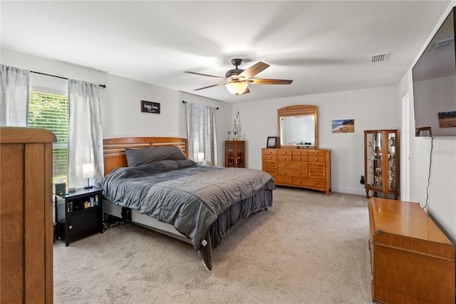 bedroom with ceiling fan and light carpet