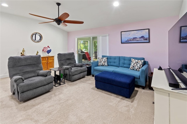 living room with ceiling fan, light colored carpet, and vaulted ceiling