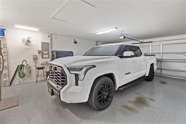 garage featuring a garage door opener and electric panel