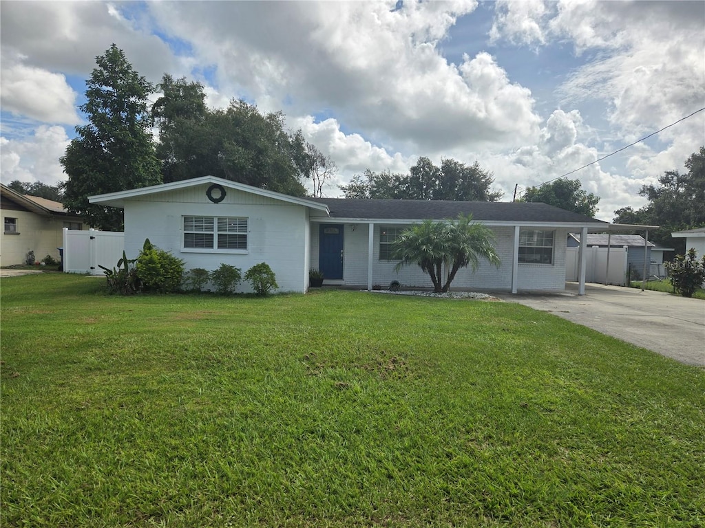 ranch-style house with a carport and a front lawn