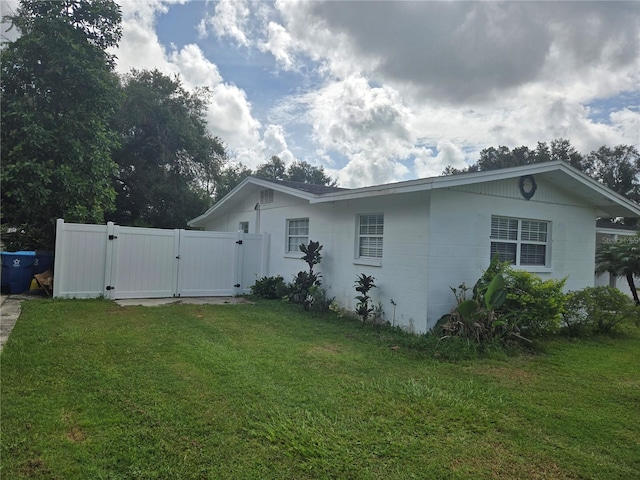 view of side of home with a lawn