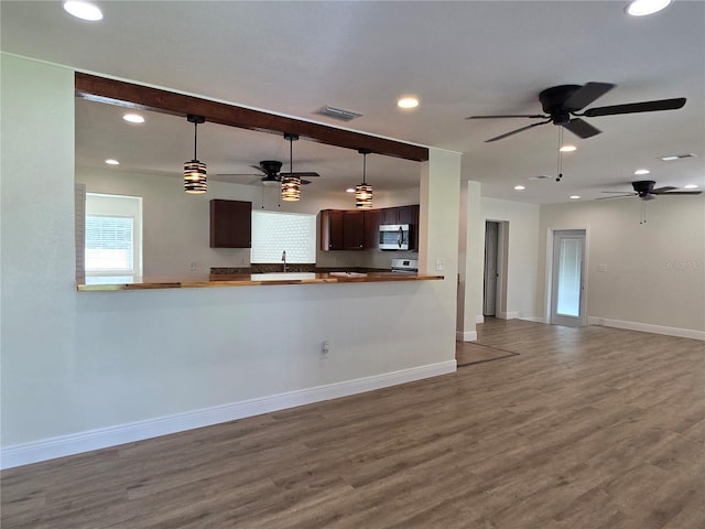 kitchen with ceiling fan, decorative light fixtures, and hardwood / wood-style floors