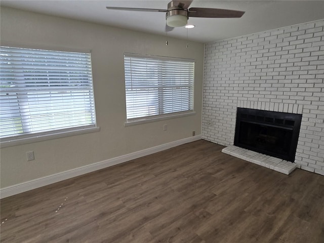 unfurnished living room featuring ceiling fan, a fireplace, and dark wood-type flooring