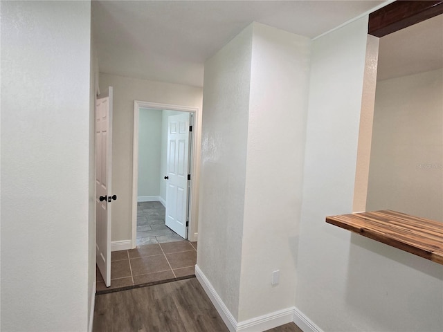 hallway with dark hardwood / wood-style floors