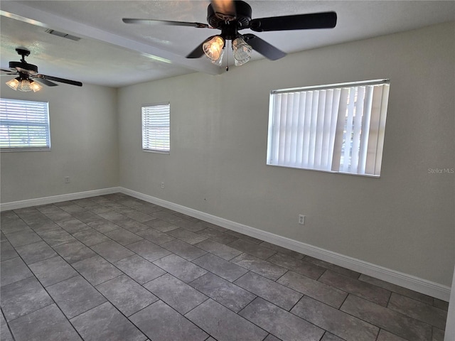 tiled spare room with ceiling fan