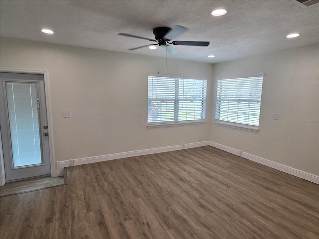 unfurnished room with a textured ceiling, dark hardwood / wood-style flooring, and ceiling fan