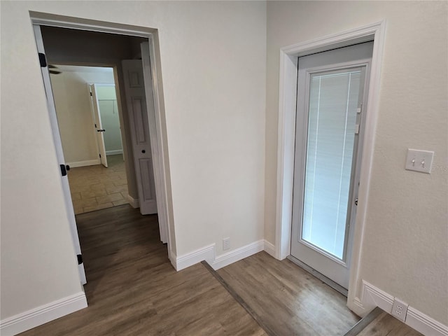 corridor with dark hardwood / wood-style floors