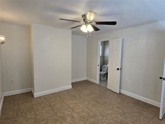 tiled spare room with ceiling fan