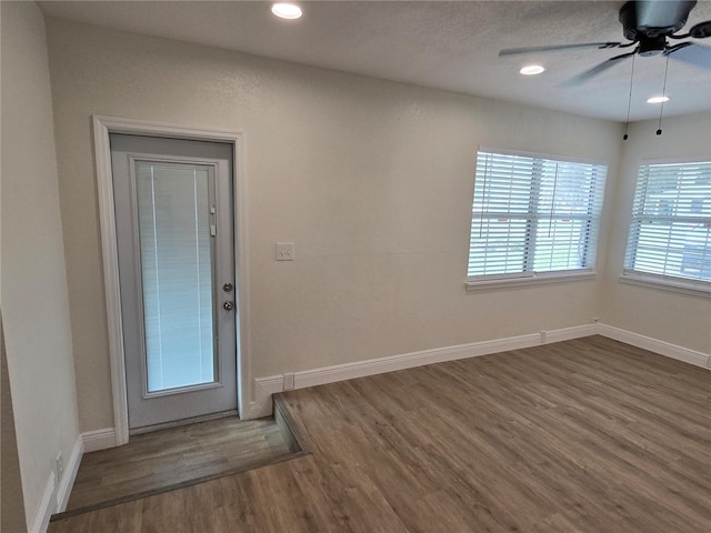 foyer entrance with wood-type flooring and ceiling fan