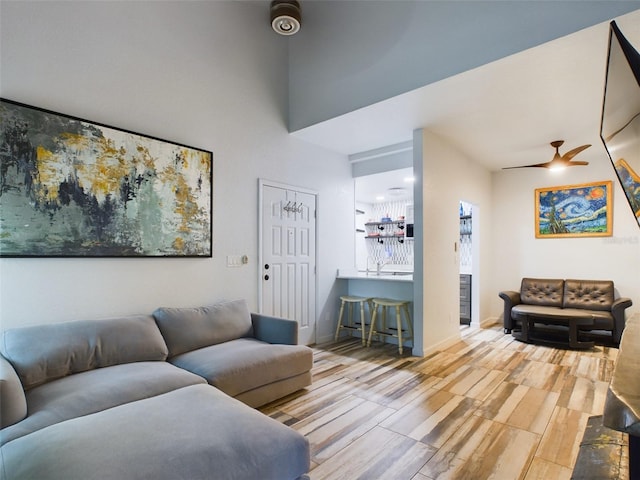 living room with wood-type flooring and ceiling fan