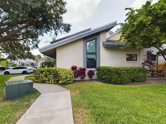 view of side of property with a lawn