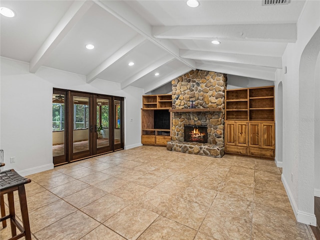 unfurnished living room featuring built in features, french doors, lofted ceiling with beams, a fireplace, and tile patterned flooring