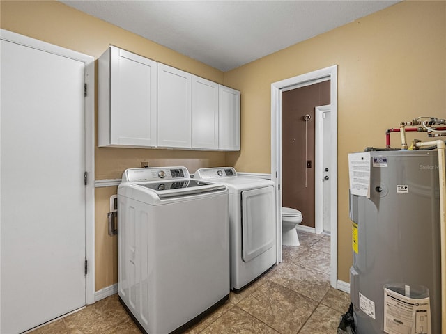 laundry room featuring cabinets, electric water heater, independent washer and dryer, and light tile patterned floors