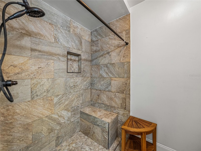 bathroom with a tile shower