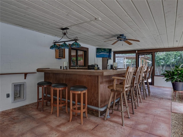 bar featuring wooden ceiling and ceiling fan