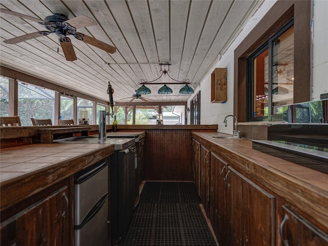 kitchen with a wealth of natural light, ceiling fan, wooden ceiling, and sink