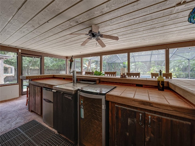 unfurnished sunroom with wooden ceiling, beverage cooler, and ceiling fan