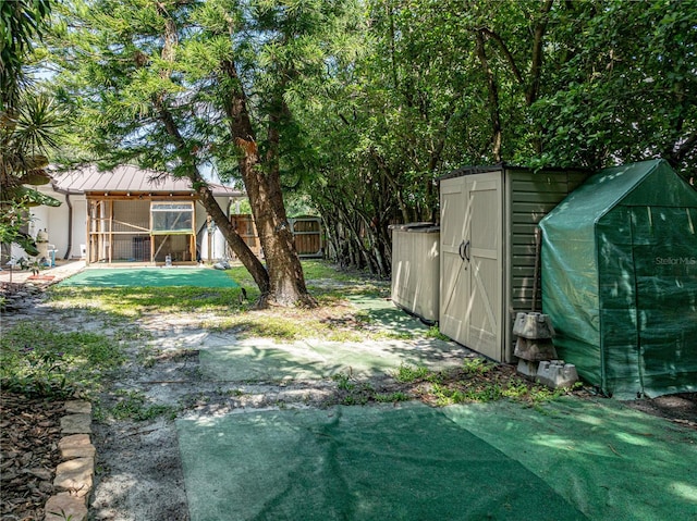 view of yard featuring a shed and a swimming pool