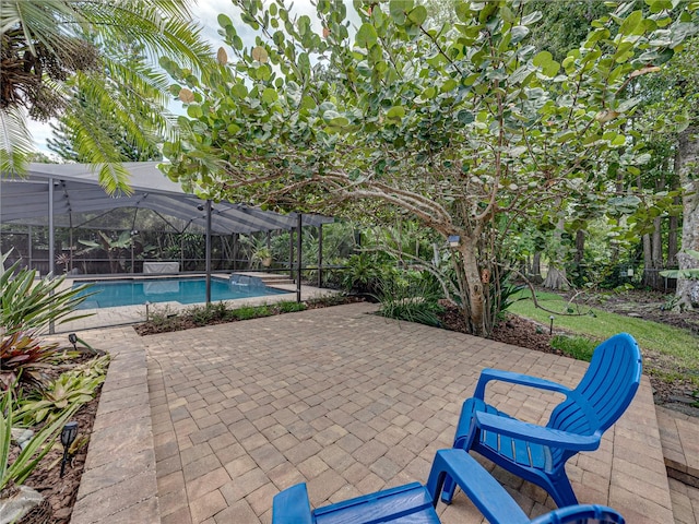 view of pool with a lanai and a patio