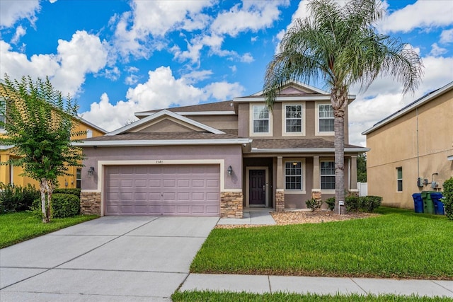 view of front of property featuring a front lawn and a garage