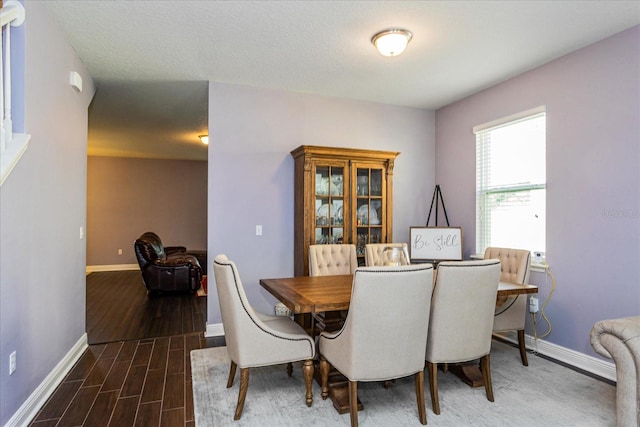 dining space featuring dark hardwood / wood-style floors