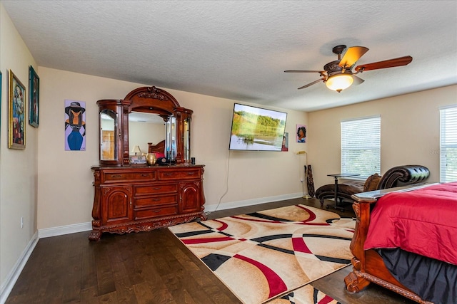 bedroom with ceiling fan, hardwood / wood-style floors, and a textured ceiling