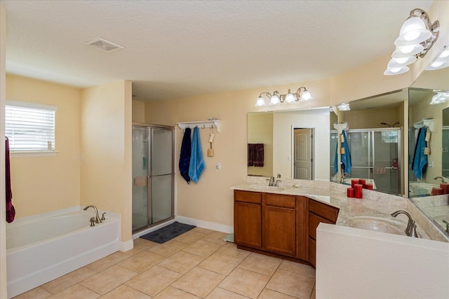 bathroom featuring vanity, separate shower and tub, a textured ceiling, and tile patterned floors