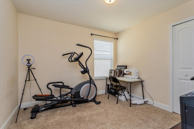 workout area featuring light colored carpet