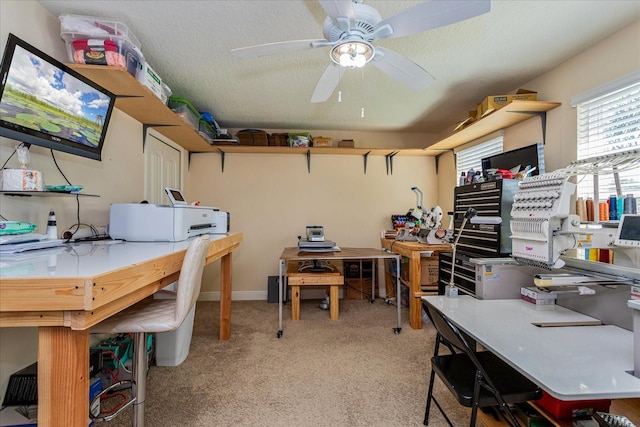 office area with a textured ceiling, ceiling fan, and light colored carpet