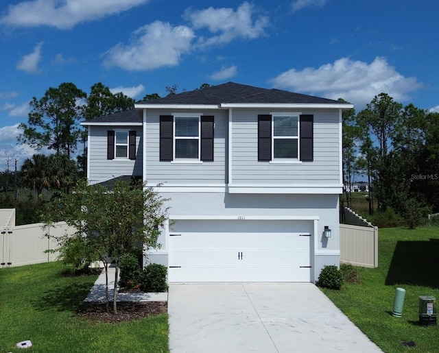 view of front of property with a garage and a front yard