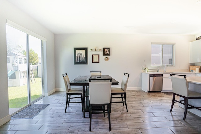 dining area featuring light wood-type flooring and sink