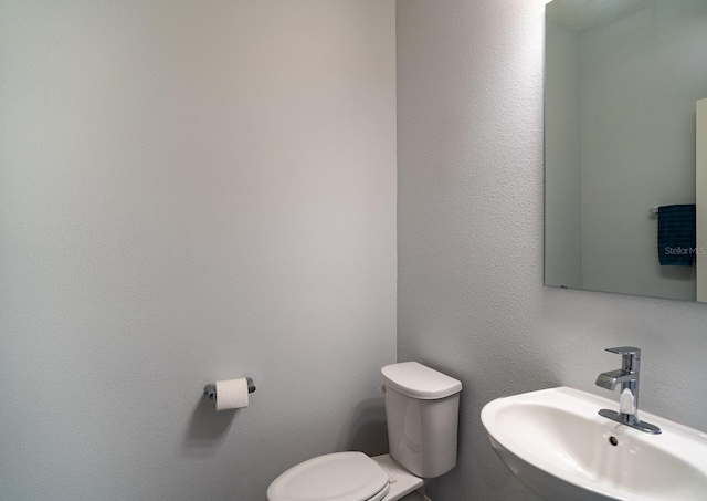 bathroom with sink and toilet