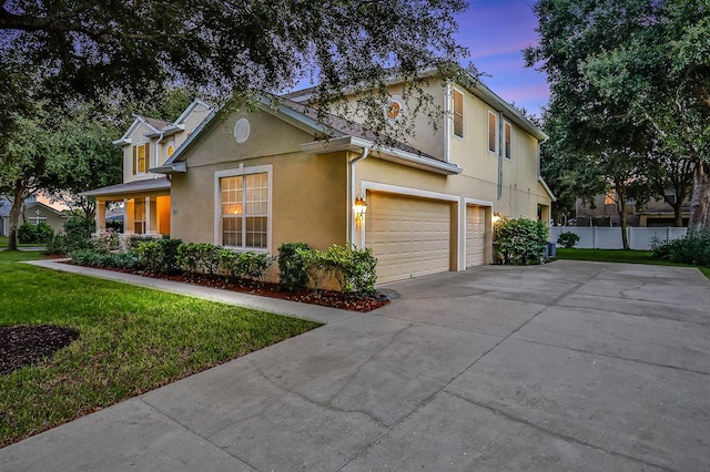 view of front of house with a garage and a yard