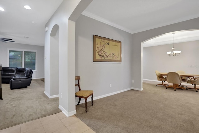 sitting room featuring light colored carpet, ceiling fan with notable chandelier, and crown molding