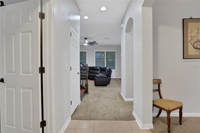 hall featuring light colored carpet