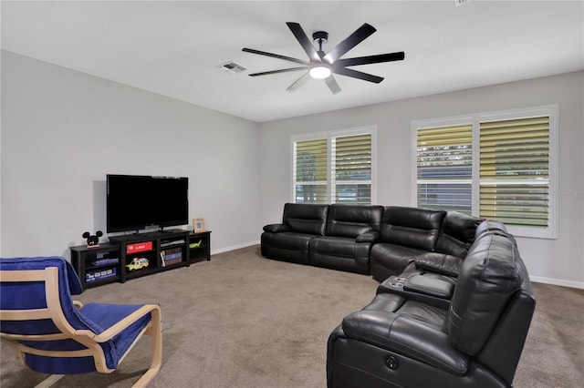 carpeted living room with ceiling fan