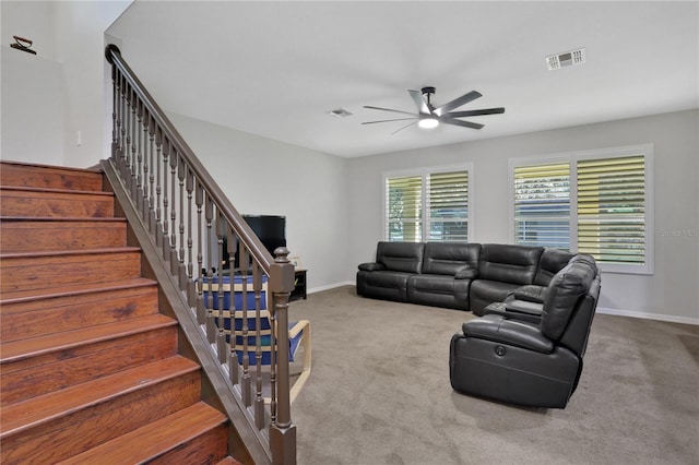 carpeted living room featuring ceiling fan