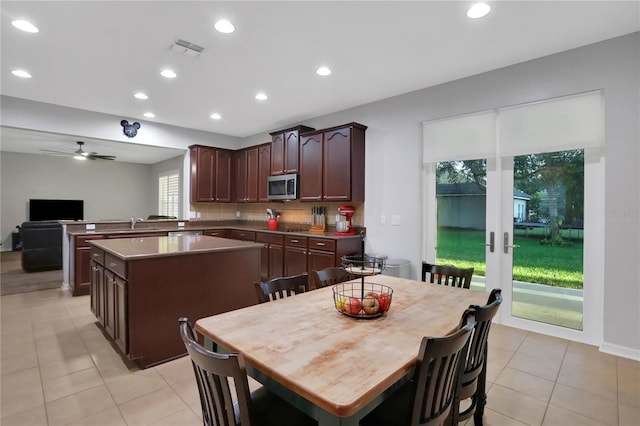 tiled dining room with ceiling fan