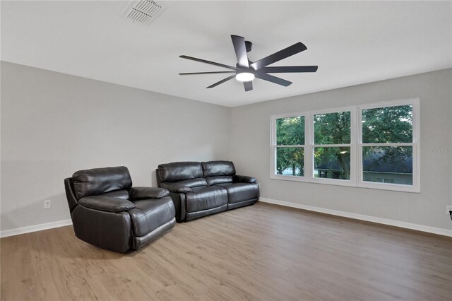 home theater room featuring light wood-type flooring and ceiling fan