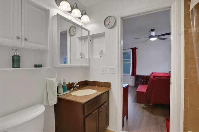 bathroom with vanity, ceiling fan, hardwood / wood-style floors, and toilet