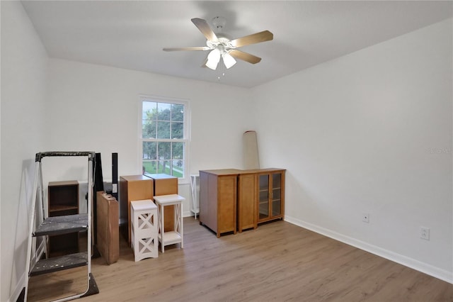 miscellaneous room with ceiling fan and light wood-type flooring