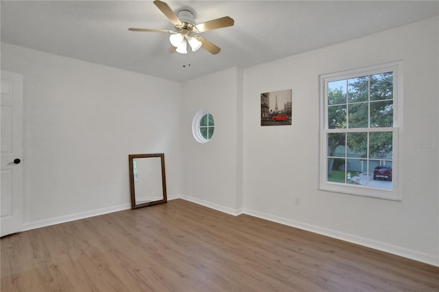 empty room with wood-type flooring and ceiling fan