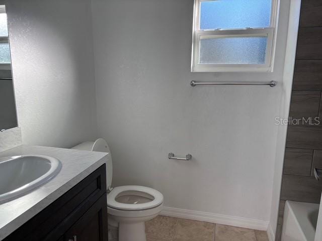 bathroom featuring tile patterned flooring, vanity, and toilet