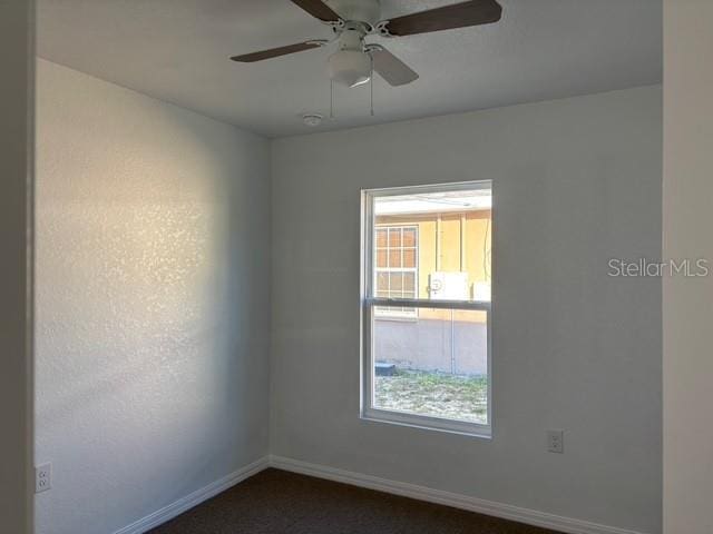 spare room with a wealth of natural light and ceiling fan